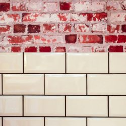 Aesthetic contrast of vintage brick with modern tile surface.